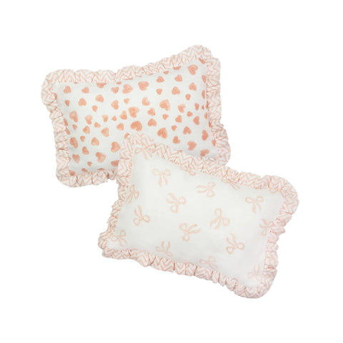 Two rectangular Muslin Ruffle Mini Pillows with floral and heart patterns in pink and white colours.