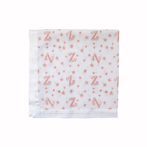White satin trimmed muslin square with pink letter 'Z' and star pattern on a white background