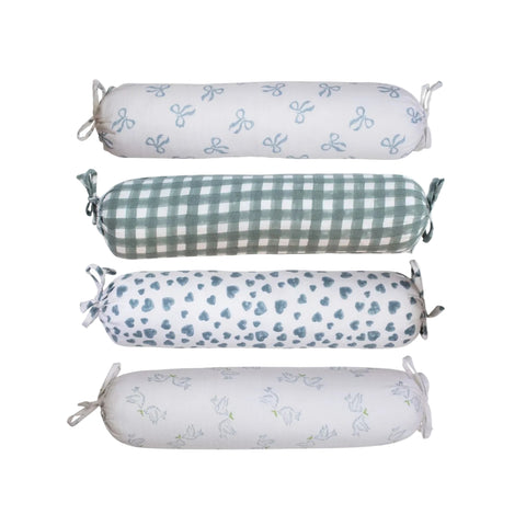 A collection of blue bolster pillows with various patterns, including solid blue, gingham, and floral prints, displayed horizontally.