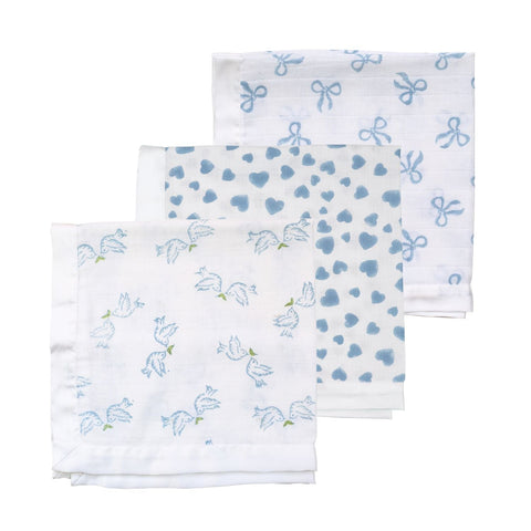 A trio of muslin cloths for babies in a range of blue block-printed designs