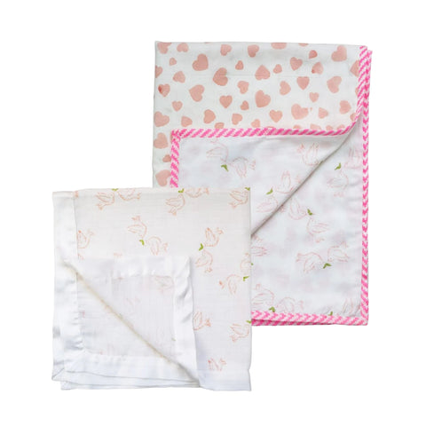 A cotton baby blanket and a muslin square in pink on a white background