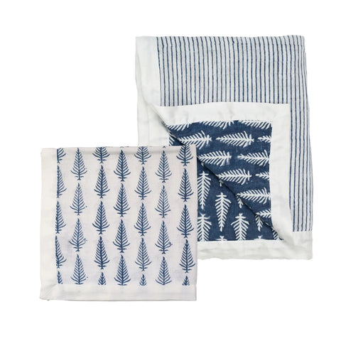 A muslin cot blanket and muslin square in indigo on a white background