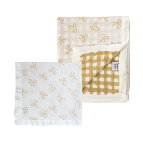 A muslin cot blanket and muslin square in taupe on a white background