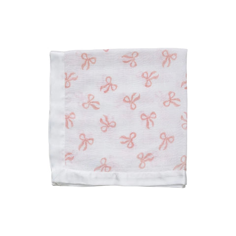 A white cotton muslin cloth with a pink bow pattern, folded neatly.