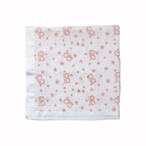 white satin trimmed muslin square with pink letter B hand printed on a white background