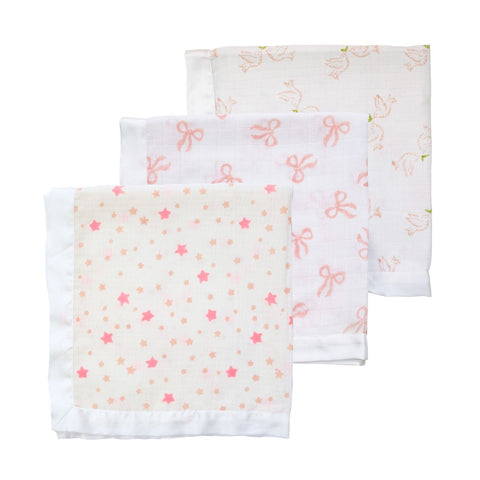 A trio of muslin cloths for babies in a range of pink block-printed designs