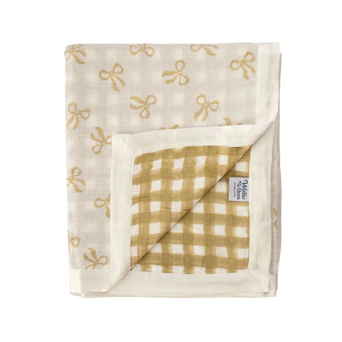 Folded fabric with taupebows and gingham pattern on a white background