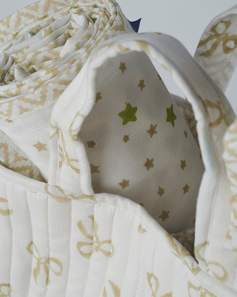 detail of taupe gift set cotton hand printed dohar and quilted nursery caddy